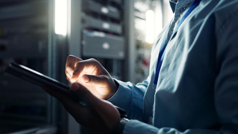 Person in the server room on a tablet